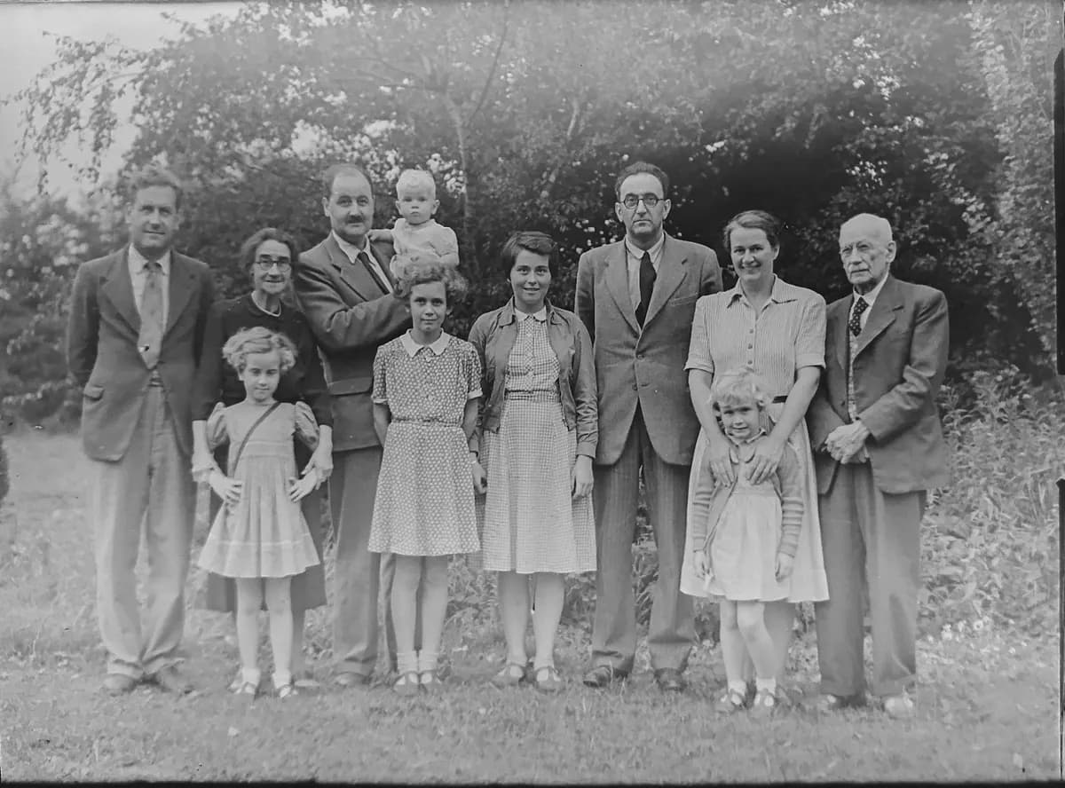A grayscale family photo standing near trees, ready to revive with Picture to Video AI