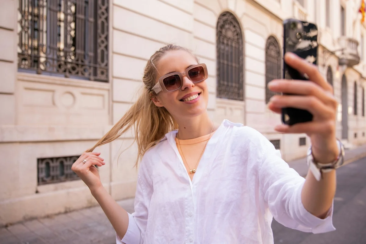 A woman taking a selfie to turn into a moving video with Picture to Video AI
